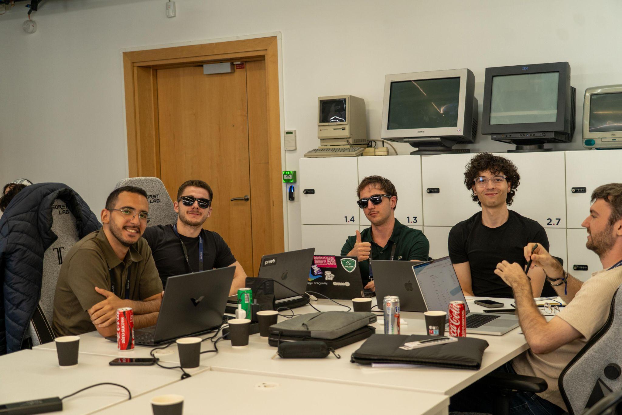 The Mantra team gathered around laptops during the RAISE Summit Hackathon