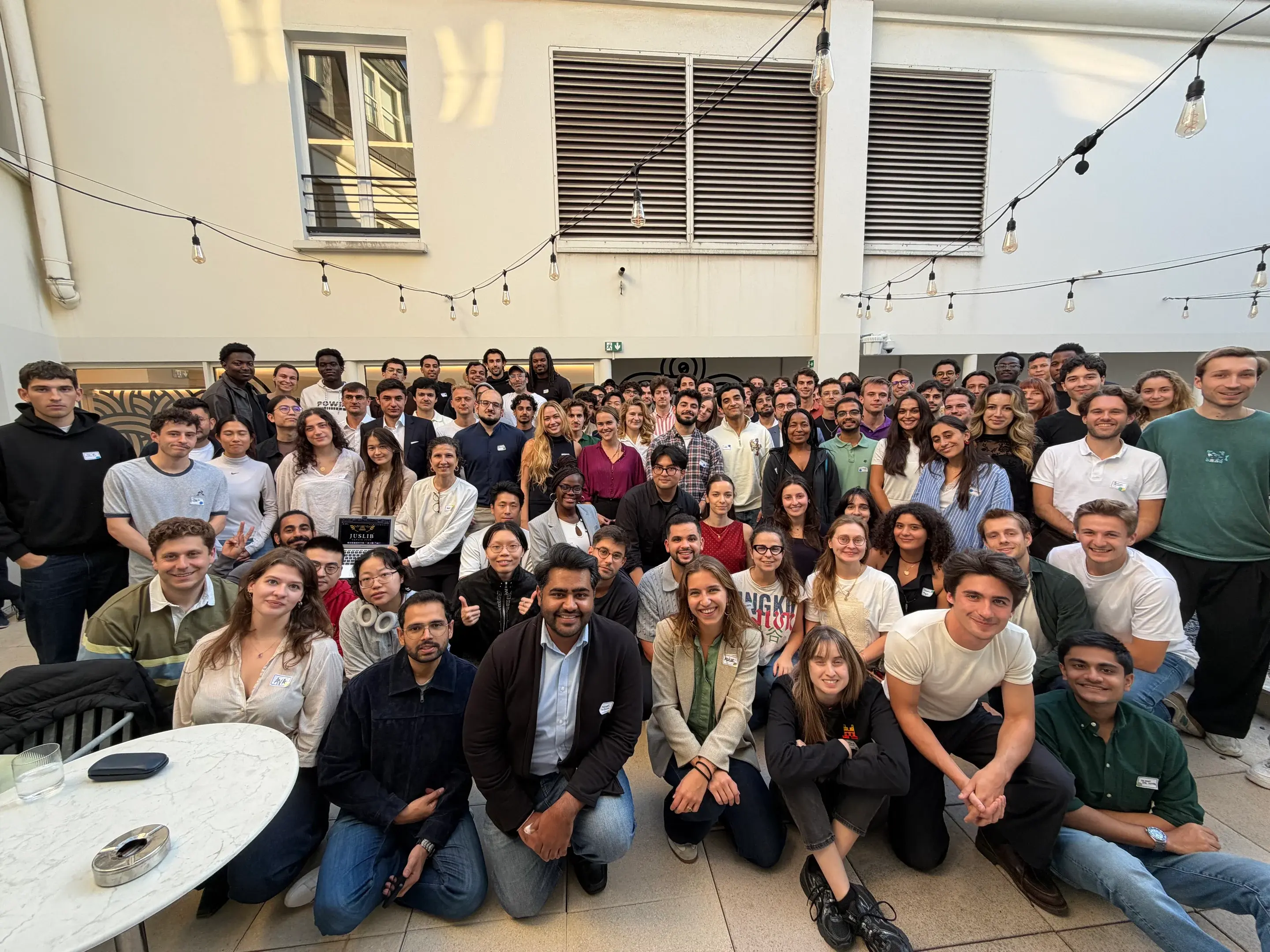 LLM x Law Hackathon participants gathered for a group photo in the courtyard